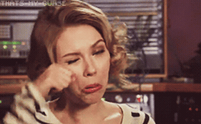 A Woman Wipes Her Face With Her Hand With The Words That 'S My Curse Written Above Her GIF