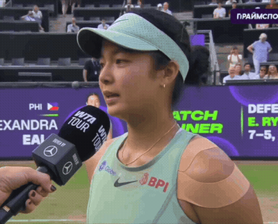 A Woman With A Bandage On Her Arm Is Being Interviewed By A Bpi Microphone GIF