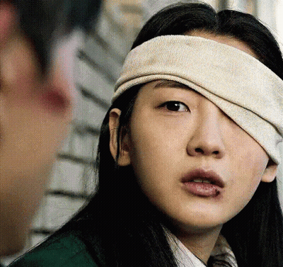 A Woman With A Bandage On Her Eye GIF