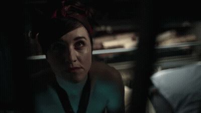 A Woman With A Bandana On Her Head Looks Up At Something GIF