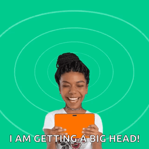 A Woman With A Big Head Is Holding A Tablet And Smiling GIF