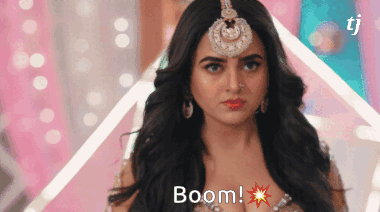 A Woman With A Bindi On Her Forehead And The Word Boom On Her Chest GIF