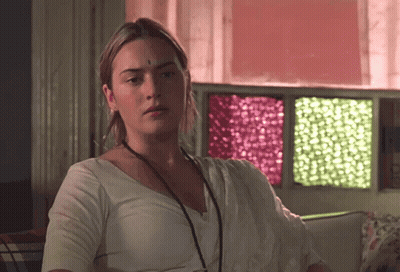 A Woman With A Bindi On Her Forehead Is Sitting In Front Of A Window GIF