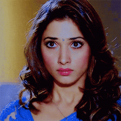 A Woman With A Bindi On Her Forehead Is Wearing A Blue Top GIF