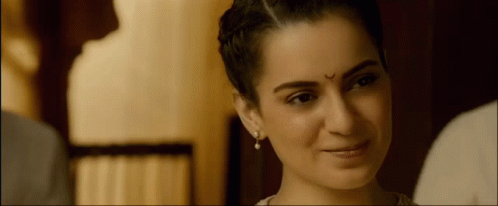 A Woman With A Bindi On Her Forehead Smiles GIF