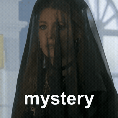 a woman with a black veil on her head and the word mystery below her