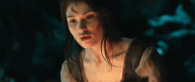 A Woman With A Bloody Face Is Holding A Torch In Her Hand . GIF