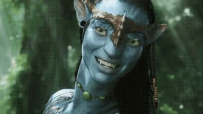 A Woman With A Blue Face And A Crown On Her Head Is Smiling GIF