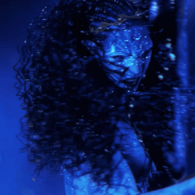 A Woman With A Blue Face Is Screaming In The Water GIF