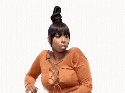 A Woman With A Bun On Her Head Is Sitting On A White Chair . GIF