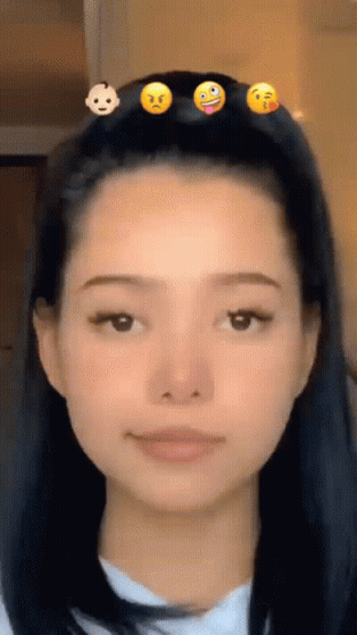 A Woman With A Bunch Of Smiley Faces In Her Hair . GIF
