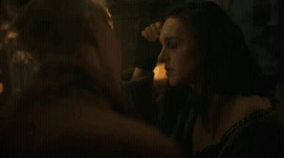 A Woman With A Choker Around Her Neck Is Looking At Another Woman GIF
