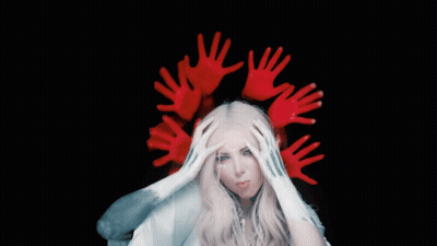 A Woman With A Crown Of Red Hands Covering Her Head GIF
