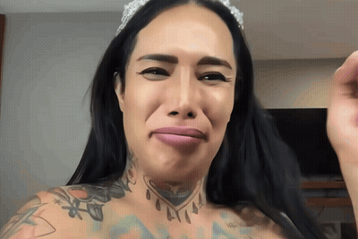 A Woman With A Crown On Her Head And A Tattoo On Her Chest GIF