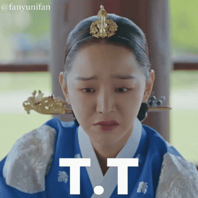A Woman With A Crown On Her Head Has The Letter T.t. On Her Face GIF