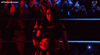 A Woman With A Crown On Her Head Is Standing In A Wrestling Ring GIF
