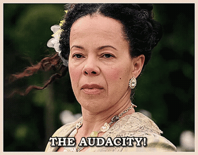 A Woman With A Flower In Her Hair And The Words The Audacity Below Her GIF