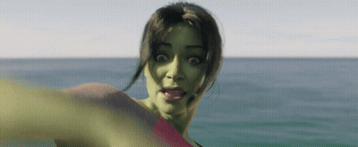 A Woman With A Green Face Is Standing In The Ocean GIF