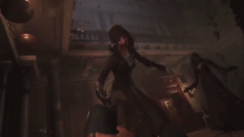 A Woman With A Hood And Keys On Her Chest Smiles GIF