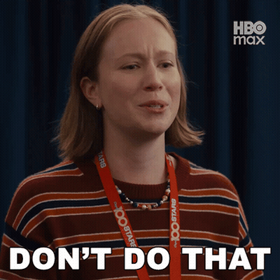 A Woman With A Lanyard Around Her Neck That Says Hbo Max GIF