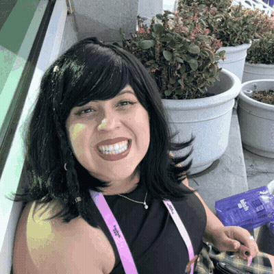 A Woman With A Lanyard Around Her Neck That Says ' Women 'S Alliance ' On It GIF