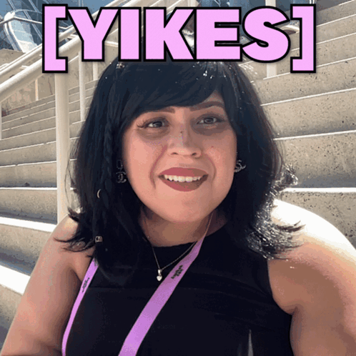 A Woman With A Lanyard That Says ' Adidas ' On It Smiles GIF