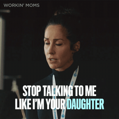 A Woman With A Lanyard That Says Workin ' Moms GIF