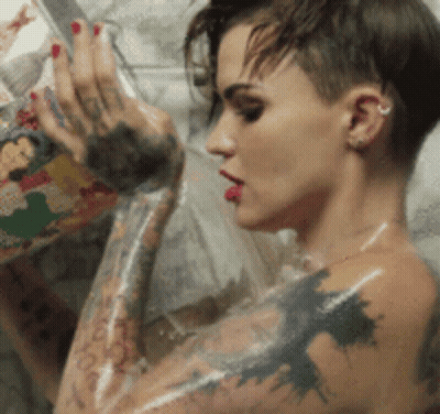 A Woman With A Lot Of Tattoos On Her Arms GIF