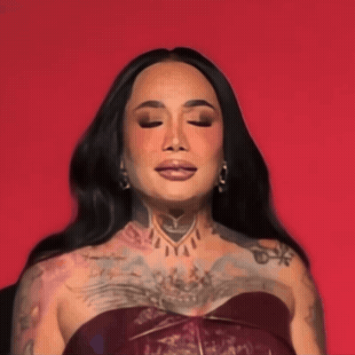 A Woman With A Lot Of Tattoos On Her Body Is Wearing A Red Top GIF