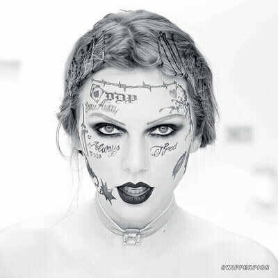 A Woman With A Lot Of Tattoos On Her Face Including One That Says " Tired " GIF