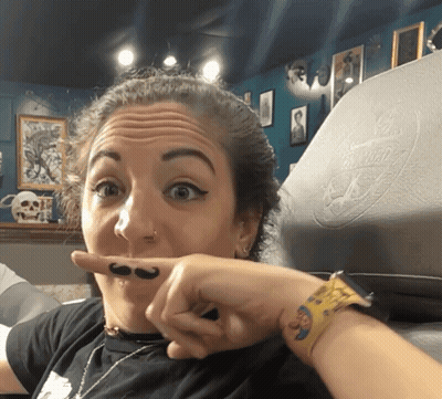 A Woman With A Mustache On Her Finger GIF