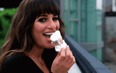 A Woman With A Necklace That Says ' I Love You ' On It Is Eating Ice Cream GIF