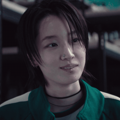 A Woman With A Nose Ring And A Choker GIF
