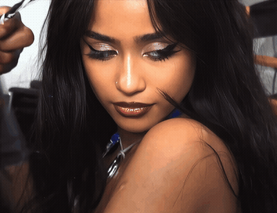 A Woman With A Nose Ring Is Getting Her Hair Done GIF