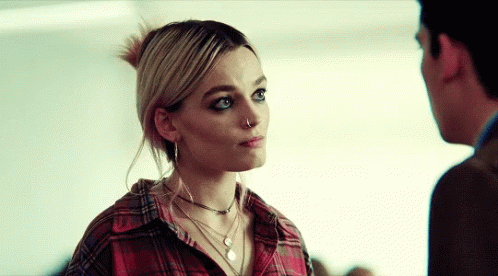 A Woman With A Nose Ring Is Looking At A Man In A Plaid Shirt GIF