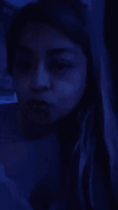 A Woman With A Nose Ring Is Making A Funny Face . GIF