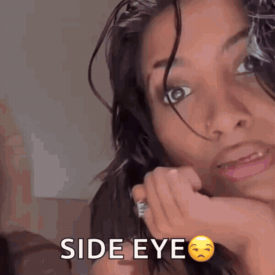 A Woman With A Nose Ring Is Making A Funny Face And Says Side Eye . GIF
