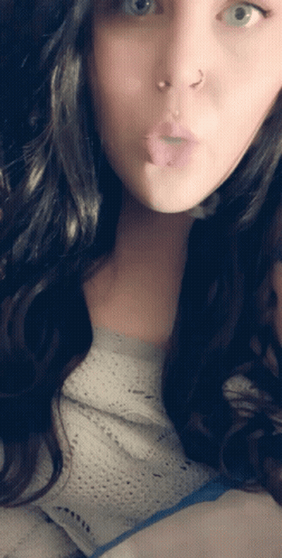 A Woman With A Nose Ring Is Making A Funny Face With Her Tongue Out GIF