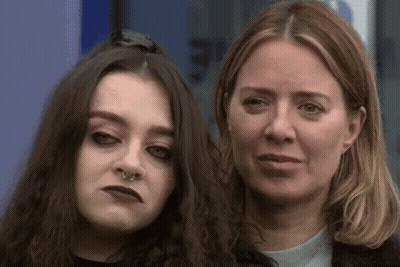 A Woman With A Nose Ring Is Standing Next To A Younger Woman GIF