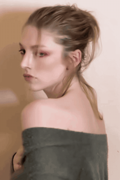 A Woman With A Ponytail Is Wearing A Green Off The Shoulder Sweater GIF