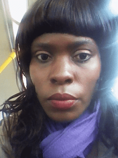 A Woman With A Purple Scarf Around Her Neck GIF