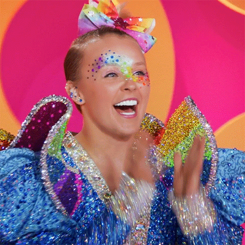 Woman With Rainbow Bow In Colorful Costume GIF