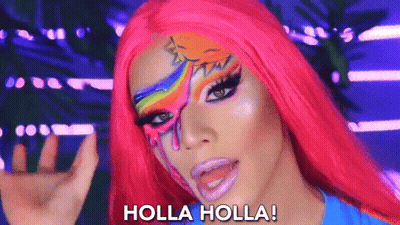 A Woman With A Rainbow Painted On Her Face Says Holla Holla GIF