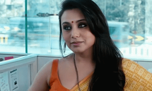 A Woman With A Red Dot On Her Forehead Is Sitting In A Cubicle GIF