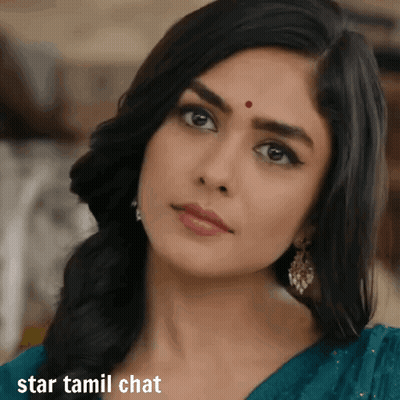 A Woman With A Red Dot On Her Forehead Looks At The Camera With The Words Star Tamil Chat Below Her GIF