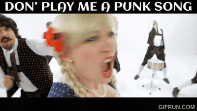 A Woman With A Red Flower In Her Hair Sings A Punk Song GIF