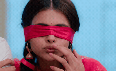 A Woman With A Red Ribbon Around Her Eyes GIF