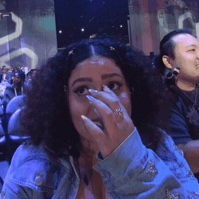 A Woman With A Ring On Her Finger Covering Her Face GIF