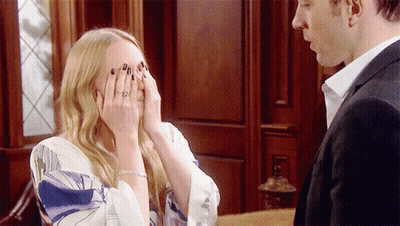 A Woman With A Ring On Her Finger Covers Her Face With Her Hands GIF