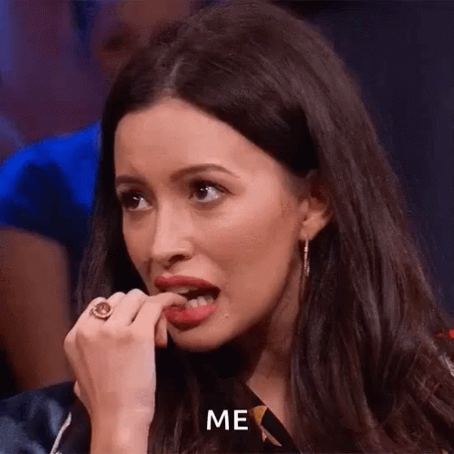 A Woman With A Ring On Her Finger Is Biting Her Nails And Says `` Me '' . GIF
